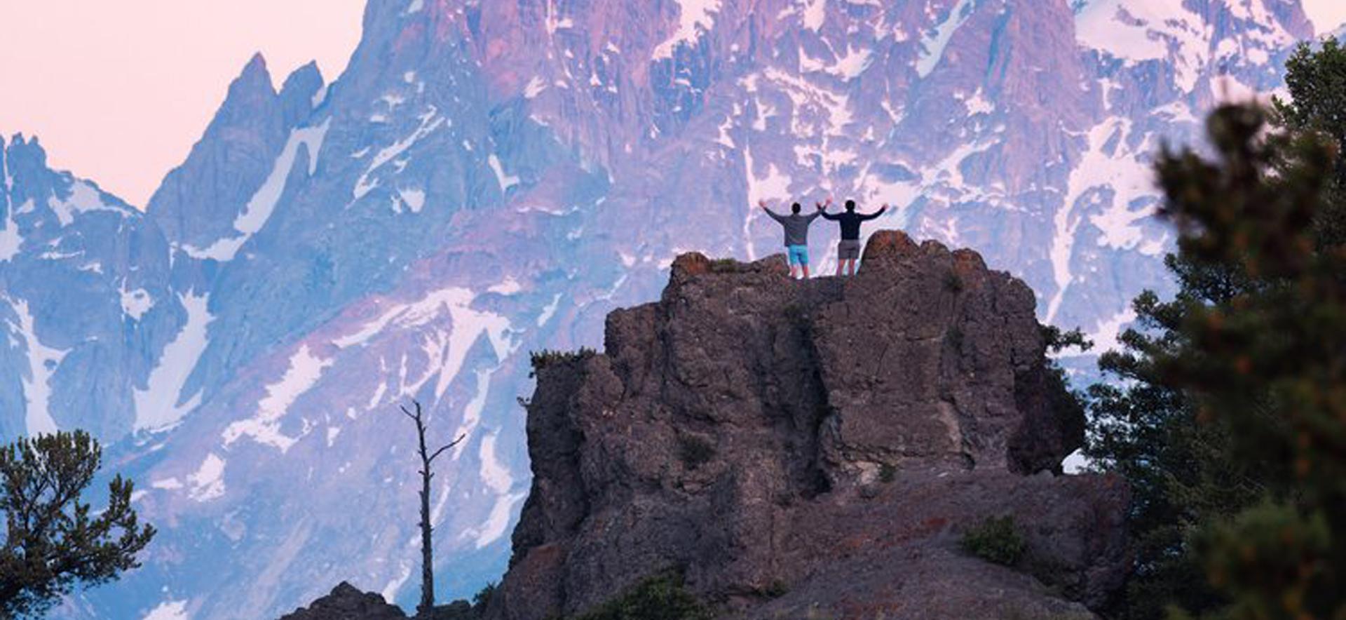 Two people on mountain peak
